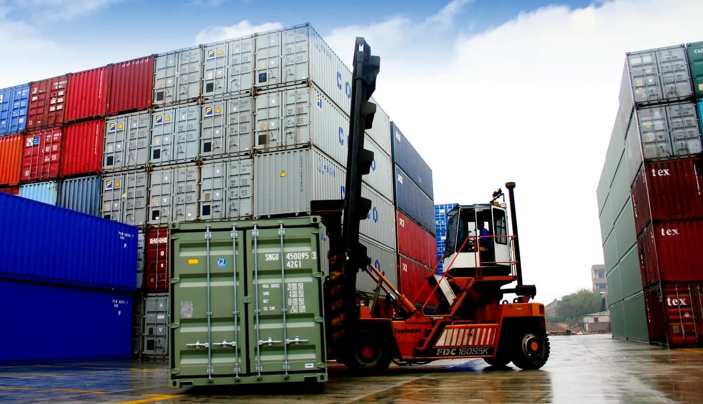 Container-handling equipment and stacked containers in a yard